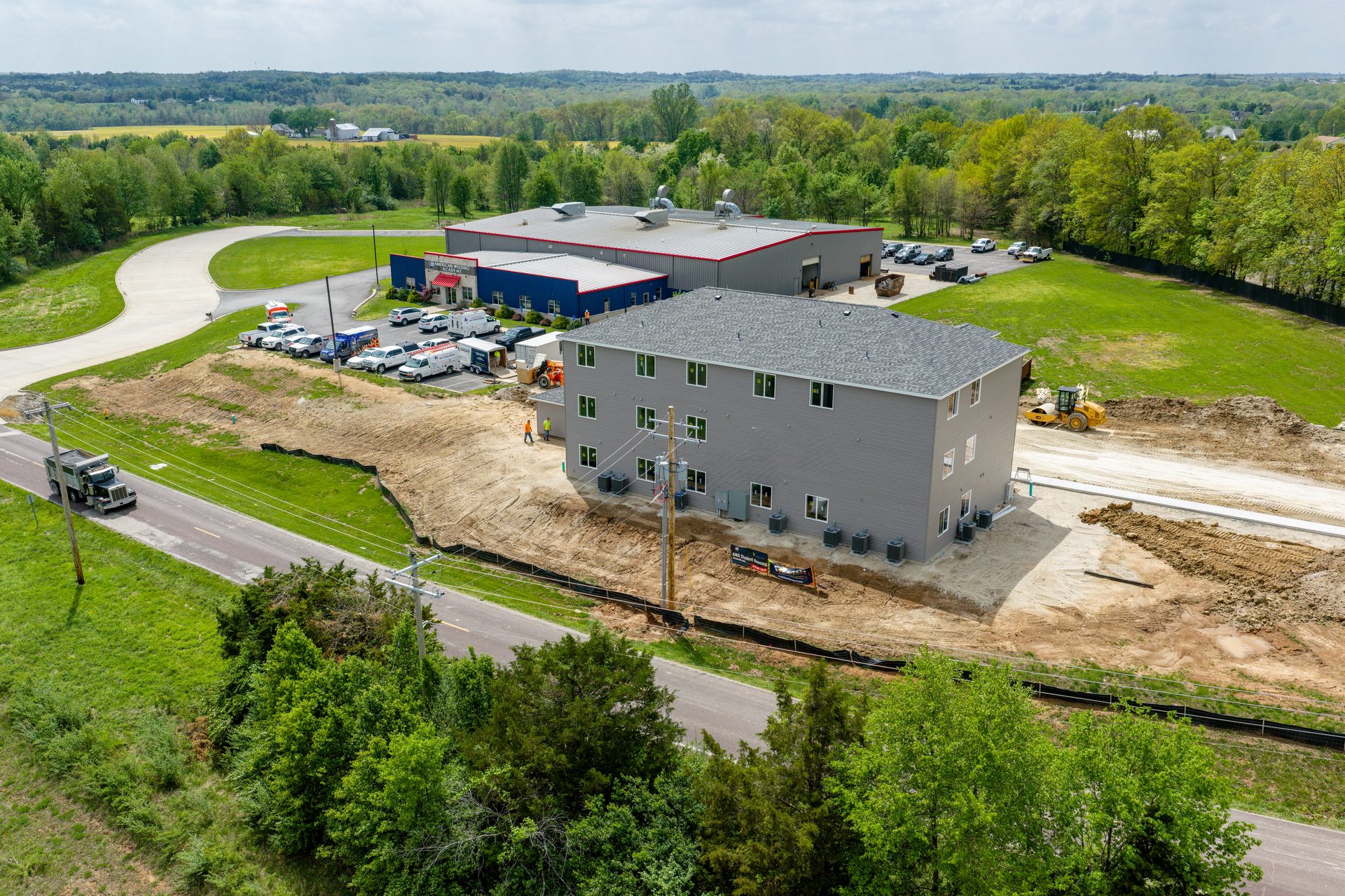 Aerial view of the American Welding Academy campus with the new building under construction and the existing main training facility visbile int he background.